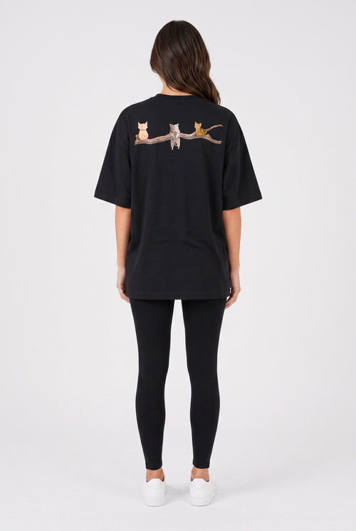 Model wearing Whimsy Tee in black, back view – Studio Drop UK streetwear