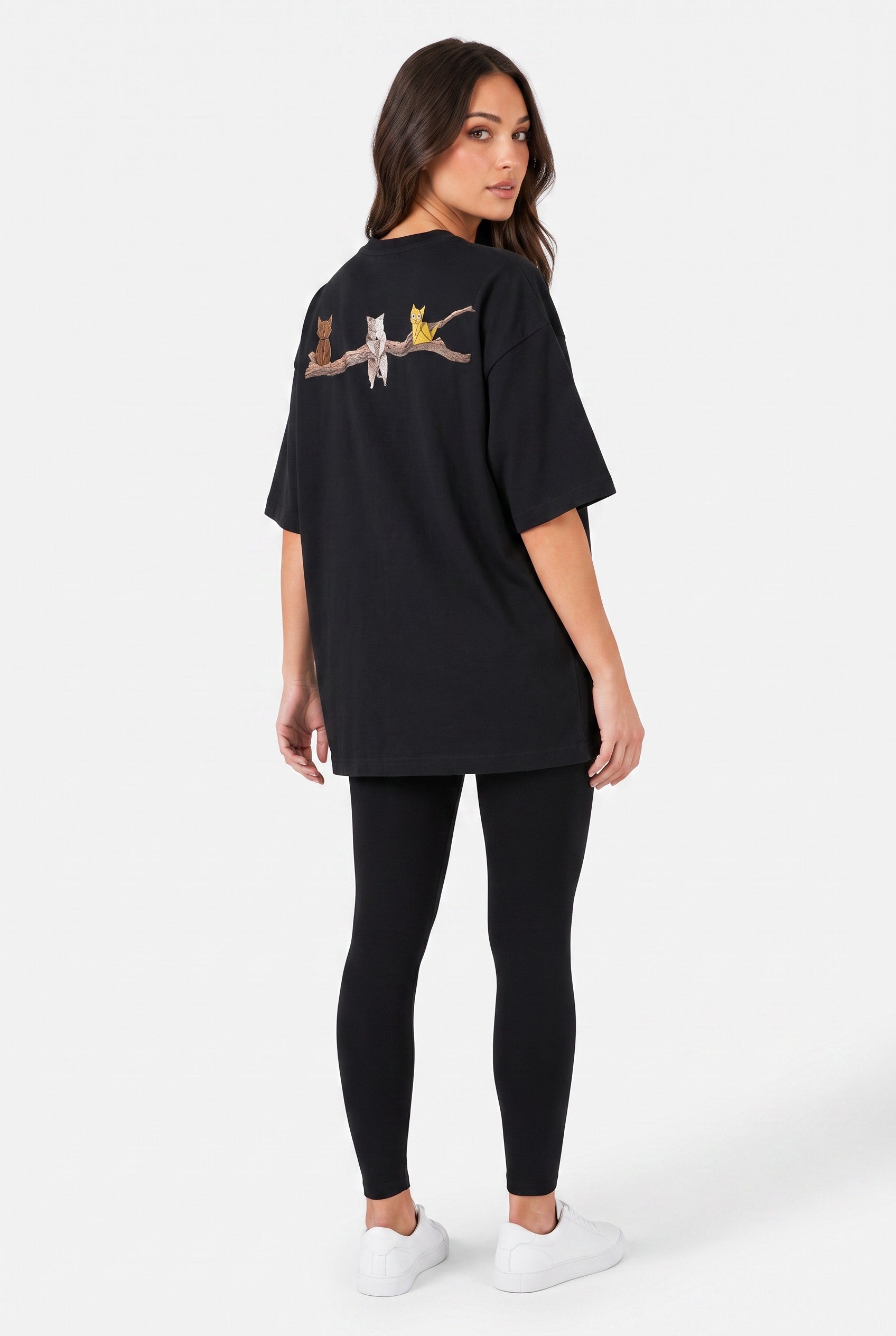 Model wearing Whimsy Tee in black, rear side view – Studio Drop UK streetwear