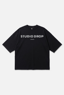 Momentum Logo Tee black oversized organic cotton T-shirt, front view – Studio Drop