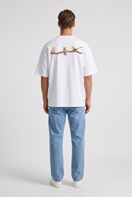 Model wearing Whimsy Tee in white, back view – Studio Drop UK streetwear