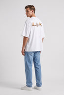 Model wearing Whimsy Tee in white, rear side view – Studio Drop UK streetwear