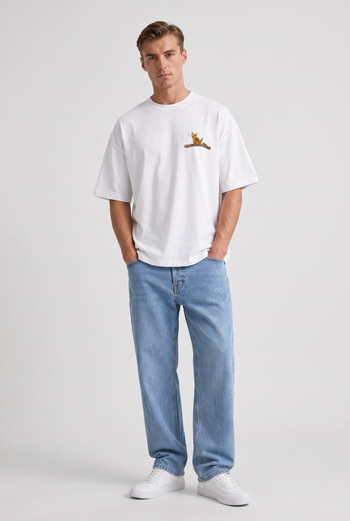 Model wearing Whimsy Tee in white, front view – Studio Drop UK streetwear